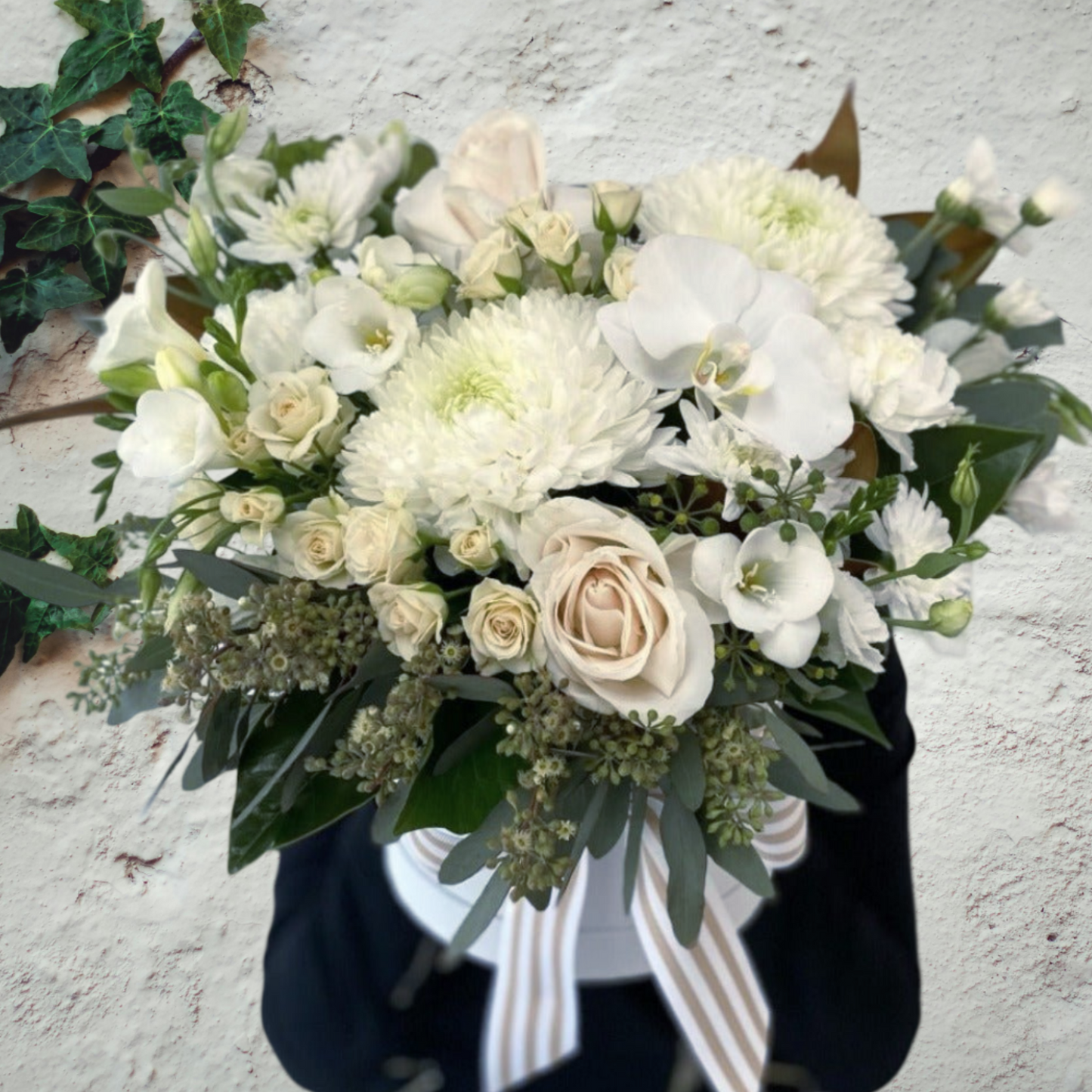 Seasonal white flowers presented in a Hatbox
