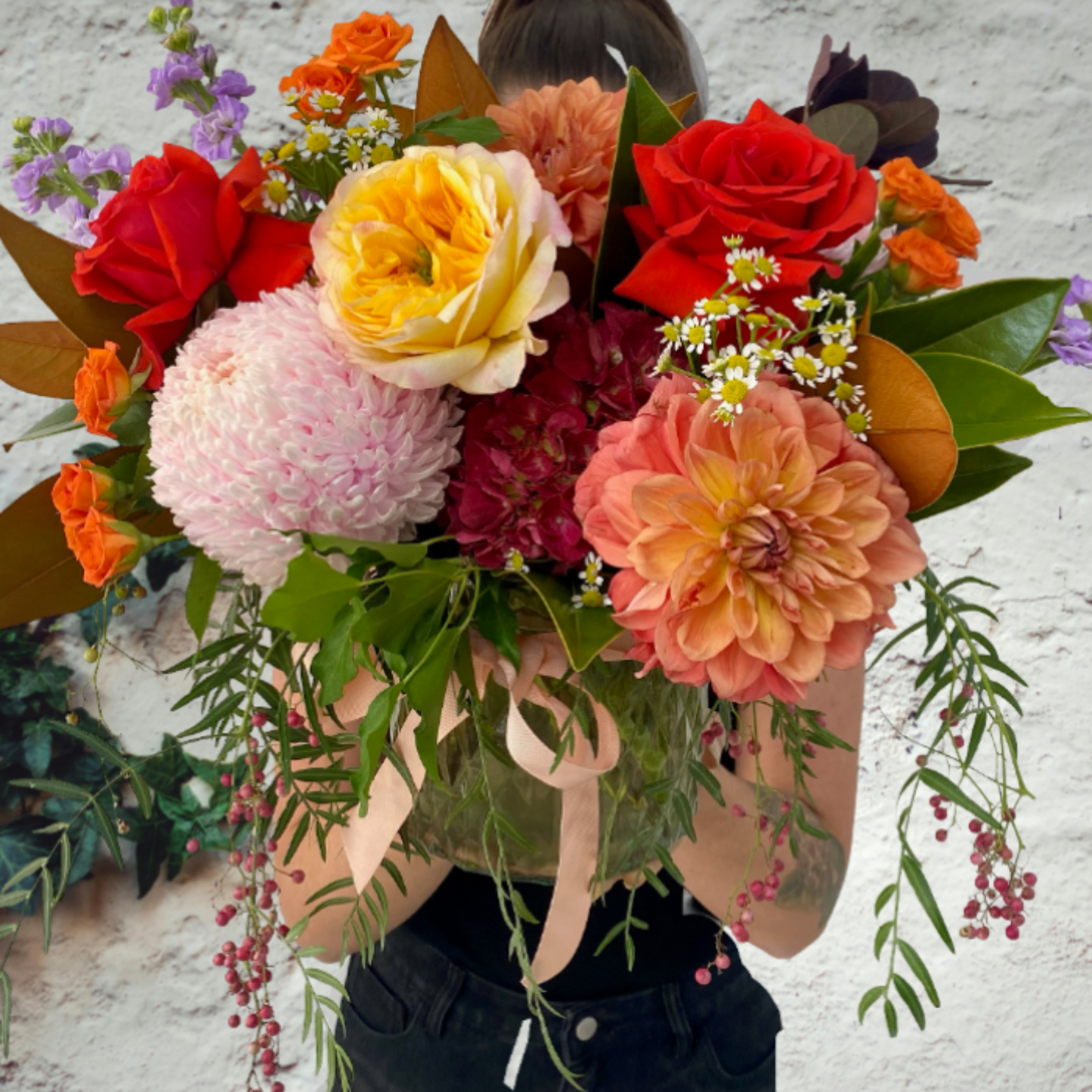 Bright Seasonal flowers presented in glass vase