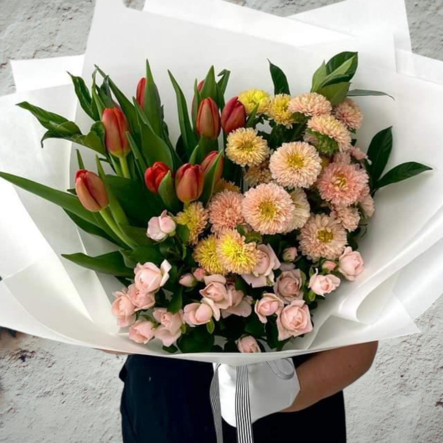 Seasonal mixed flowers presented as a bouquet